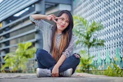 Young woman sitting outdoors