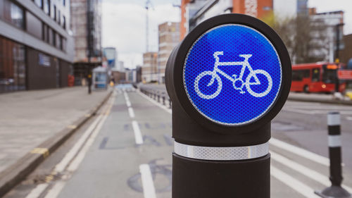 Cycle route sign on a bollard in a city centre