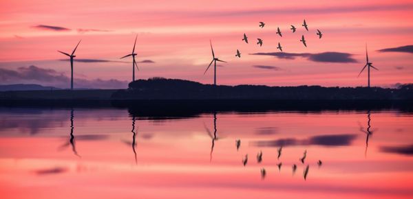 Scenic view of lake against orange sky