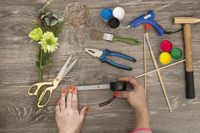 High angle view of hand holding flower bouquet on table