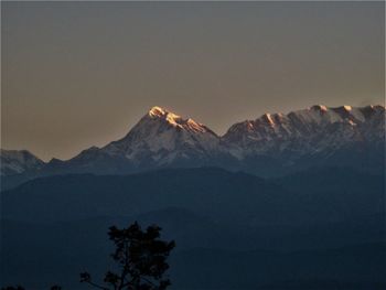 Scenic view of snowcapped mountains against sky during sunset