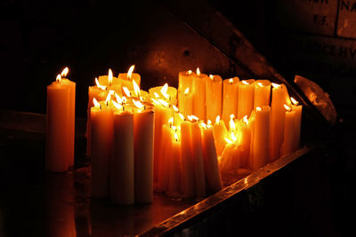 Close-up of lit candles in temple