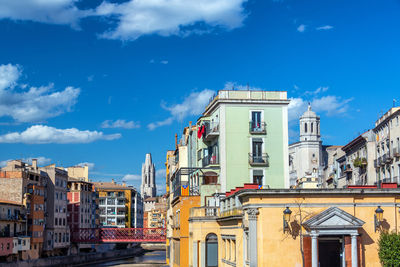 Buildings in city against blue sky