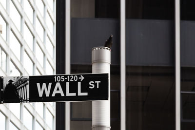 Wall street sign on building