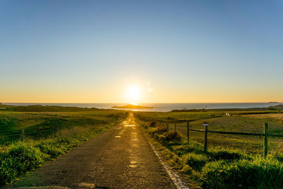 Scenic view of field against sky during sunset