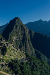 Scenic view of mountains against clear blue sky