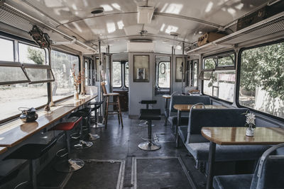 Empty chairs and tables in bus