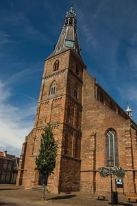 Steeple on the church facade made of bricks in weesp. a pleasant small village in netherlands.