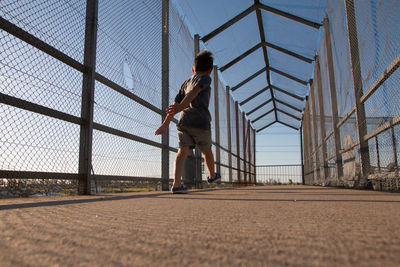 Low angle view of child walking in city