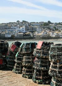 Aerial view of city by sea against sky