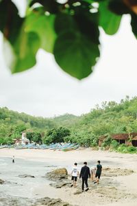 Group of people walking on beach