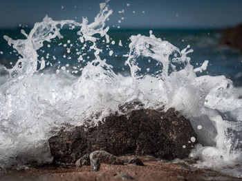 Close-up of wave splashing on rock