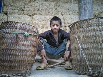 Portrait of senior man sitting on wall