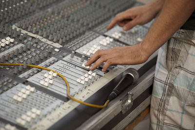 Close-up of hand using sound mixer