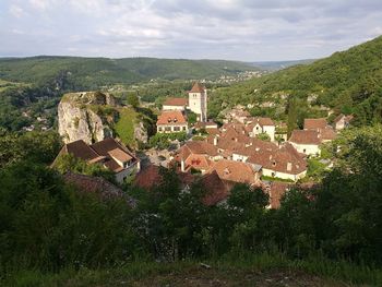 Houses on hill against sky