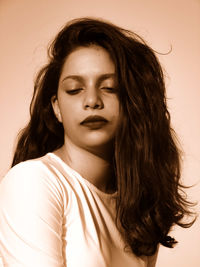 Close-up of beautiful young woman over white background