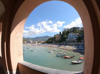 Panoramic view of sea and cityscape against sky