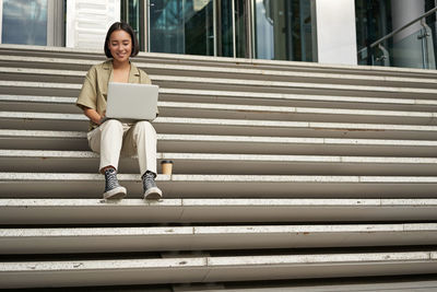 Young woman sitting on steps