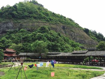 People on field against mountain