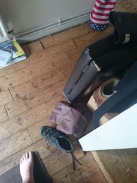 Low section of woman holding umbrella