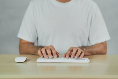 Midsection of man holding book