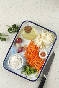 Ingredient making bakwan bala-bala, carrot, cabbage, oil, garlic, salt, pepper, onion, and flour.