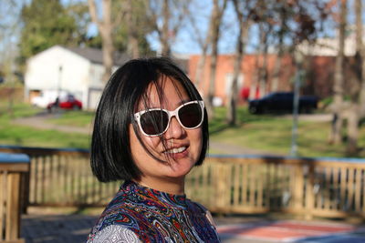 Portrait of smiling young woman wearing sunglasses