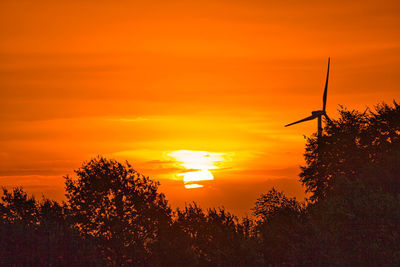 Silhouette plants against romantic sky at sunset