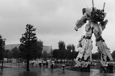 Group of people in park against sky