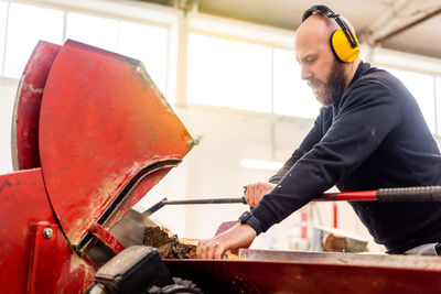 Side view of man working in workshop