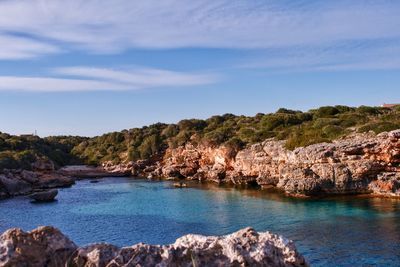 Scenic view of sea and rocky mountains