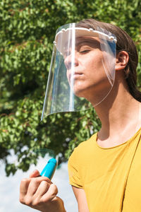 Close-up woman using hand fan