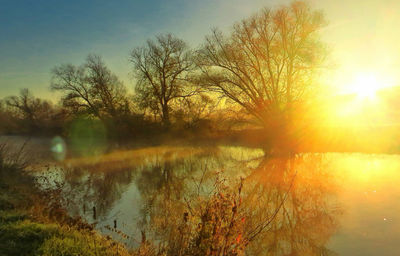 Scenic view of lake against sky during sunset