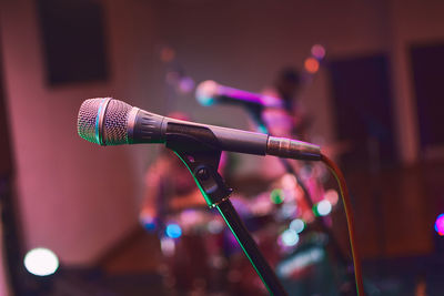 Close-up of microphone against illuminated lights