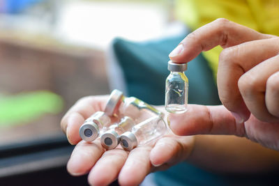 Close-up of hand holding bottle