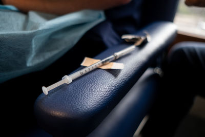 Close-up of syringe on leather