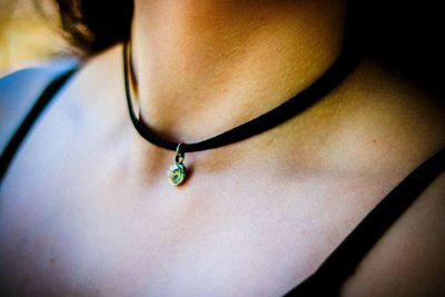 Midsection of woman wearing choker