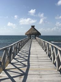 Pier over sea against sky