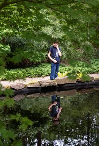 Full length of man standing by lake