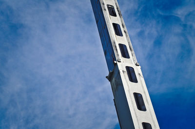 Low angle view of tower against blue sky