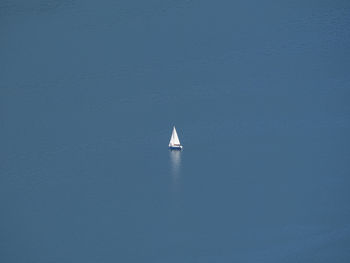 Sailboat sailing in sea against sky