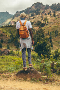 Rear view of man standing on mountain