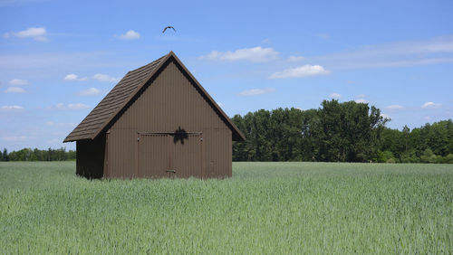 Built structure on field against sky