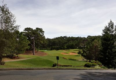 Scenic view of golf course against sky