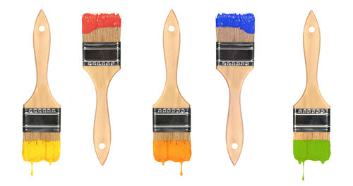 Close-up of paintbrushes against white background