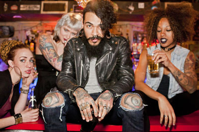 Full length of a young man drinking glasses