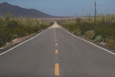 Empty road along countryside landscape