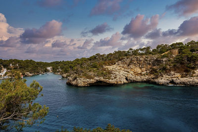 Beautiful view of mediterranean sea and rocky cliff against sky during sunset