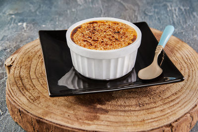 Creme brulee with mushrooms in special form on plate with spoon