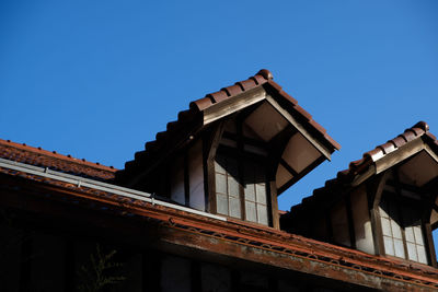 Low angle view of old building against clear blue sky